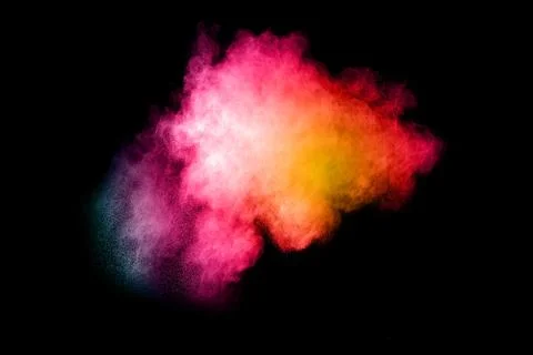 The explosion of multi colored powder. Beautiful powder fly away. Stock Photos