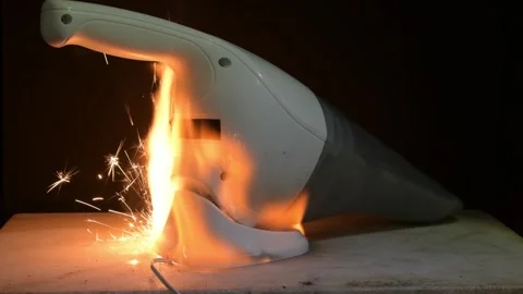 An explosion or short circuit in a portable hoover while charging is a household Stock Footage 309485019