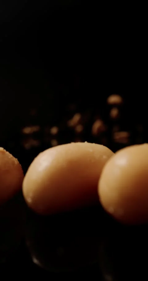 An explosion of peanuts surges forward, their textured shells creating a Stock Footage 310053828