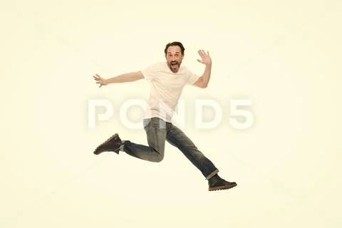 Explosion of positive emotions. Man excited jumping. Mature charismatic speaker Stock Photos