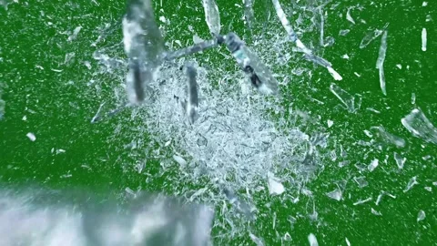 Explosion of shattered ice fragments with motion and light effects on green.. Stock Footage 328472227