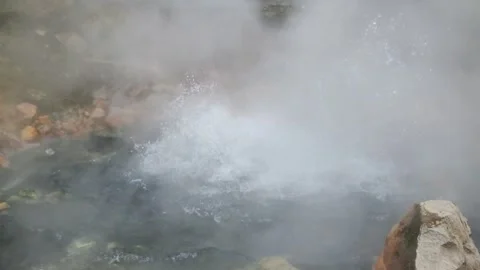 Explosion of sulfur water in an active crater covered in hot steam Stock Footage 307419733