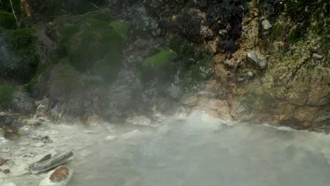 Explosion of sulfur water in an active crater covered in hot steam Video stock 307420458