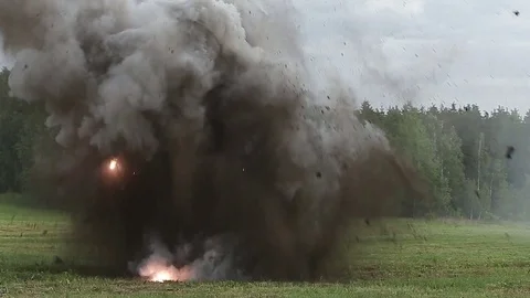 Explosion throws earth fire and smoke. Video stock 76963748