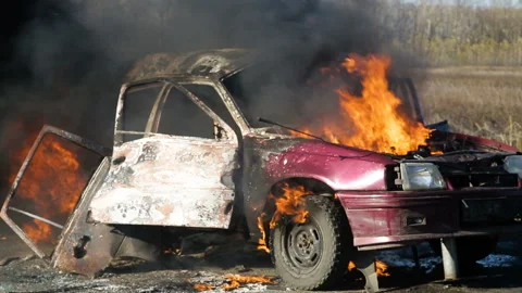 The explosion of the wheel of a car burning on the highway. Car on fire on the Video stock 98652485