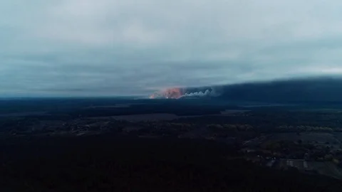 Explosions and fire in the smoke with the ammunition flying out, aerial shot Stock Footage 96497645