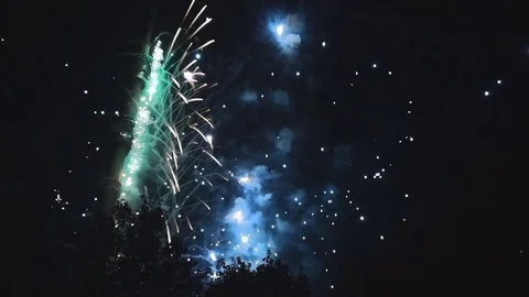 Explosions of colored fireworks in the night sky Stock Footage 82369007