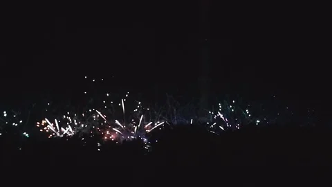 Explosions of colored fireworks in night sky Stock Footage 82369098