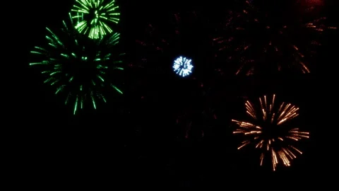 Explosions of multi-colored festive fireworks in the dark sky 1 Stock Footage 283087063