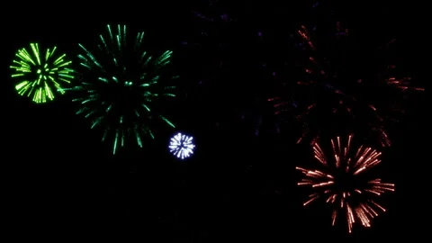 Explosions of multi-colored festive fireworks in the dark sky Stock Footage 283087165