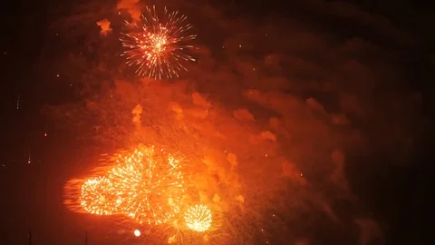 Explosions of multi-colored salute or fireworks in night sky Stock Footage 107820345