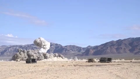 Explosions in Nevada desert from weapons fired from A-10 Thunderbolt II aircraft Stock Footage 227138450