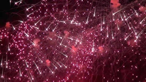 Explosions of ruby light paint the night sky in celebration Stock Footage 320520737