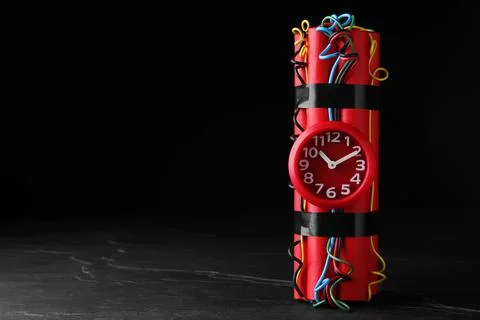 Explosive dynamite time bomb on black background. Space for text Stock Photos