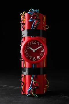Explosive dynamite time bomb on black background Stock Photos