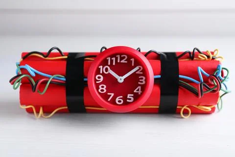 Explosive dynamite time bomb on white wooden background Stock Photos
