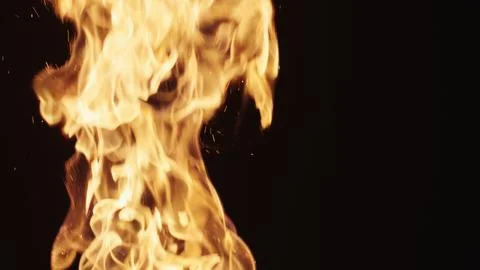 Explosive fire flames of campfire over black background, for overlay Stock Photos