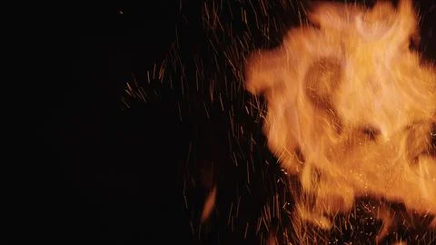 Explosive fire flames of campfire over black background, for overlay Stock Photos