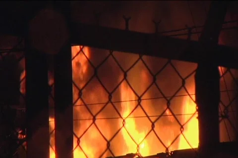 Explosive Fire Seen From Behind Fence 動画素材 857554