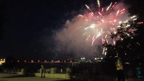 Explosive Fireworks At Night With Traffic Security Guard Looking Around Stock Footage 225620014