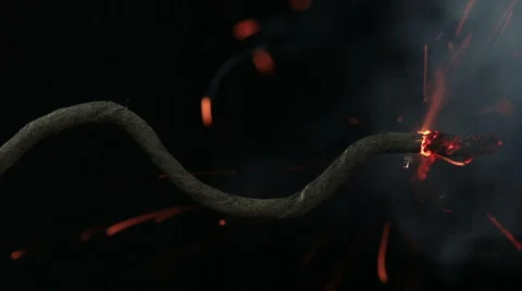 Explosive fuse ignited by a match and burns out quickly on black background Stock Footage 58483074