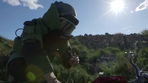 Explosive ordnance disposal expert examines possible IED bomb Stock Footage 72259156