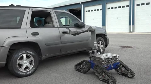An explosive ordnance disposal robot opening a car door Video stock 284217635