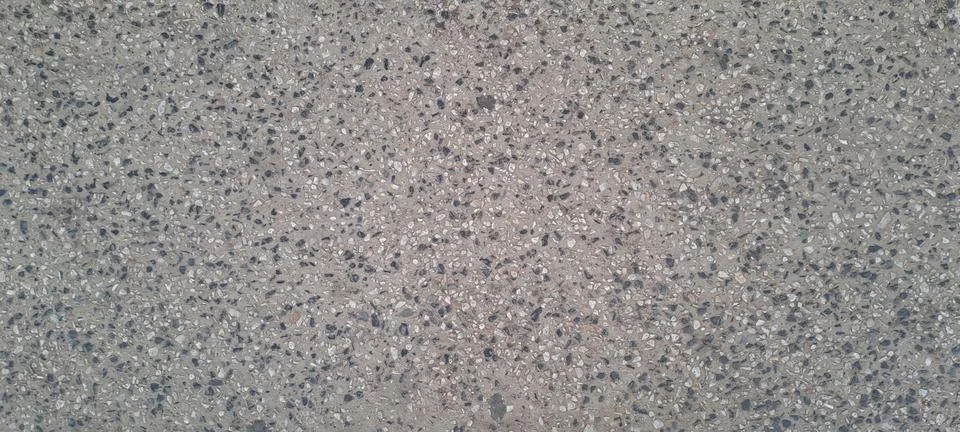 Exposed aggregate concrete surface forming textured background Stock Photos