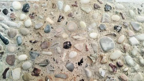 Exposed aggregate concrete texture background with colorful pebble wash. Stock Photos