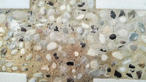 Exposed aggregate concrete texture background with colorful pebble wash. Stock Photos