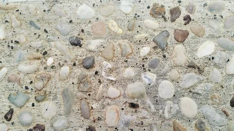 Exposed aggregate concrete texture background with colorful pebble wash. Stock Photos