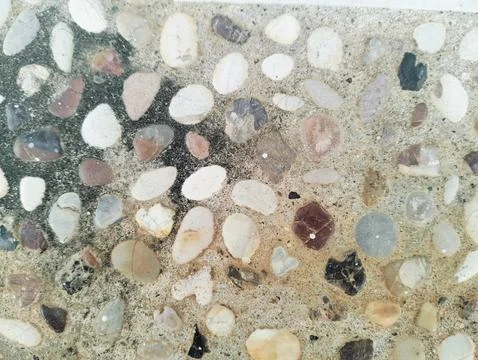 Exposed aggregate concrete texture background with colorful pebble wash. Stock Photos