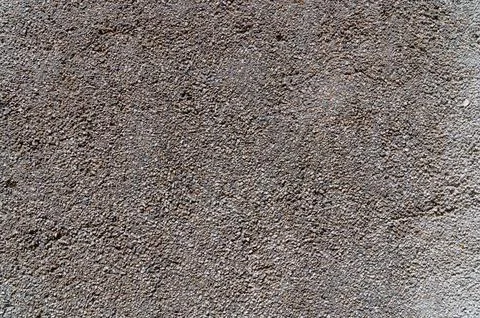 Exposed aggregate concrete texture background. Close-up view of a rough wal.. Stock Photos