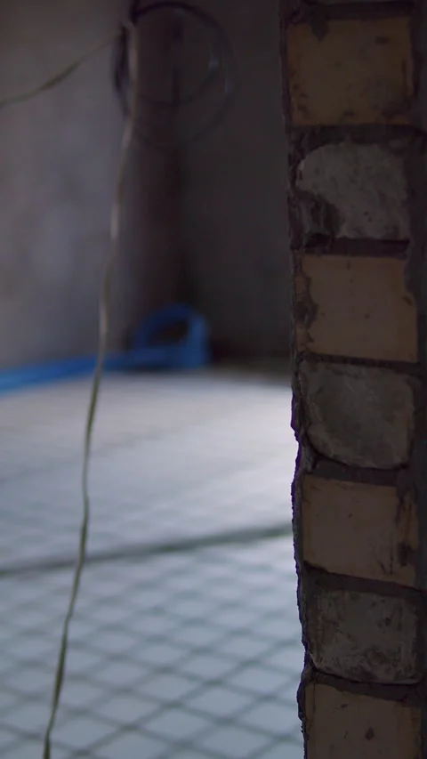 Exposed brick wall inside unfinished building with visible wiring Stock Footage 312097563