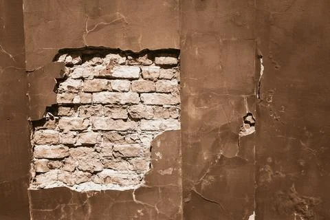 Exposed brick wall with peeling plaster in Mocha and Mousse tones Foto stock