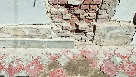 Exposed Brickwork and Damaged Plaster on an Interior Wall with Old Flooring Vídeos de archivo 346441270