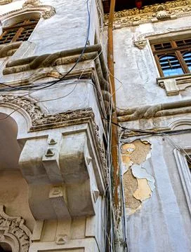 Exposed cables hanging in a mess on a facade Stock Photos