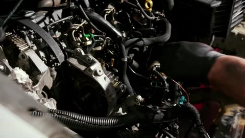 Exposed car engine block with hoses wiring and components in garage Stock Footage 337777671