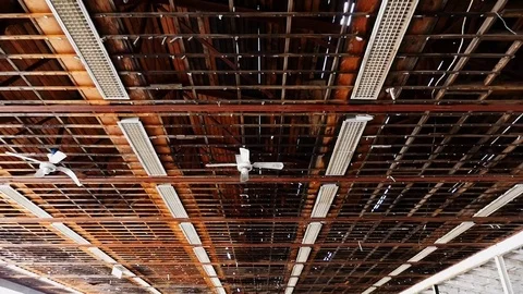 Exposed ceiling framing in a rundown, decrepit warehouse Stock Footage 72562014
