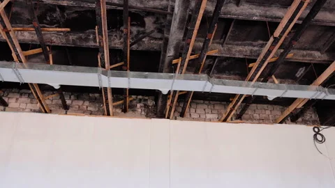 Exposed ceiling structure showing wooden beams and metal ductwork, highlighting Stock Footage 319535917