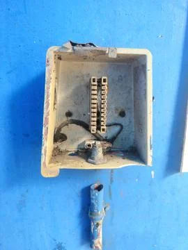 Exposed electrical connection box on a blue wall Stock Photos