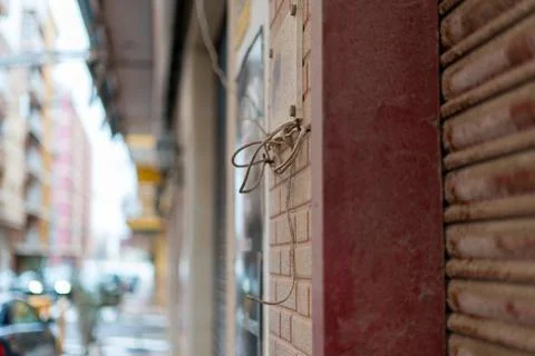 Exposed electrical wires on building wall unsafe wiring Stock Photos