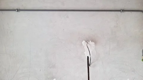 Exposed Electrical Wires Emerging from Plastered Wall for Repair Stock Footage 338372982