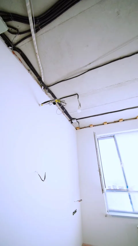 Exposed Electrical Wiring and Bare Bulbs Across Concrete Ceiling Stock Footage 342990676