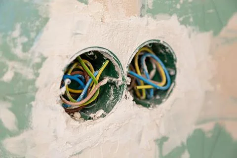 Exposed electrical wiring inside unfinished gypsum wall background Stock Photos
