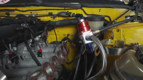Exposed engine parts under industrial workshop lighting. Mechanic examining Stock Footage 336862636