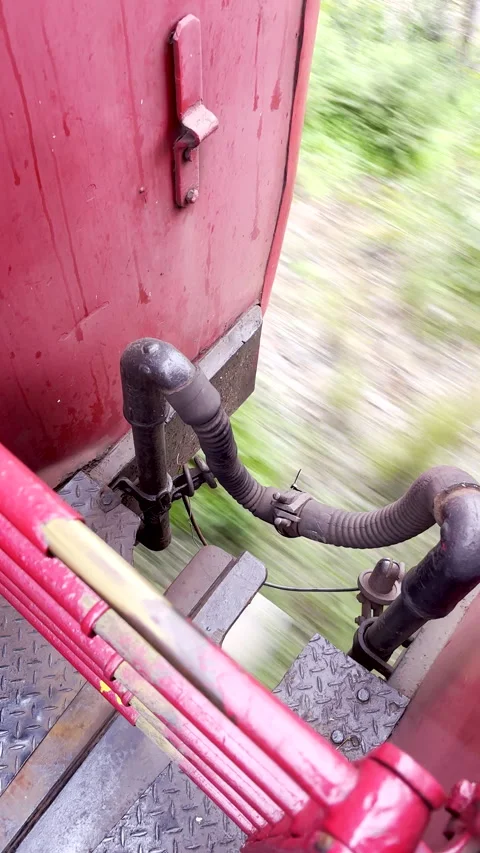 Exposed gangway between two carriages of old train moving on track Stock Footage 346246318