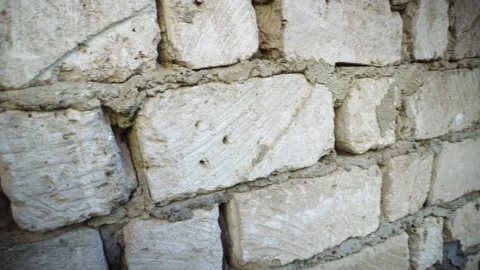 Exposed Limestone Block House Wall with Window and Rough Mortar Joints Stock-Footage 345979595