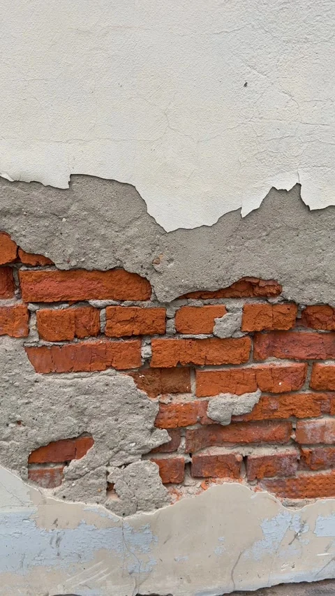 Exposed red brick wall with peeling plaster, showcasing texture and industr.. Stock Footage 318657876
