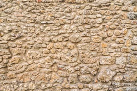 Exposed stone wall background, pattern, texture in Tuscany. Stock Photos